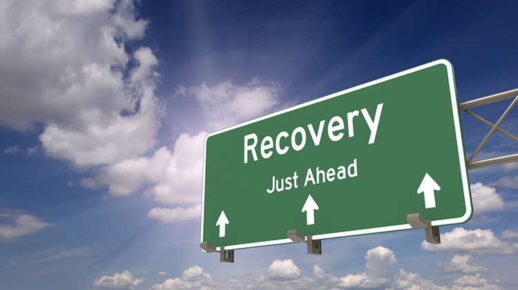 Schild auf der Autobahn mit Aufschrift: Recovery, just ahead